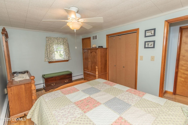 2256 Crossroads Dr, Lewisburg, PA 17837 - bedroom with a baseboard radiator, wood finished floors, a closet, and ornamental molding