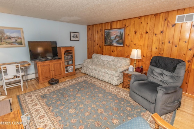 2256 Crossroads Dr, Lewisburg, PA 17837 - living room with light wood finished floors, wood walls, and baseboard heating