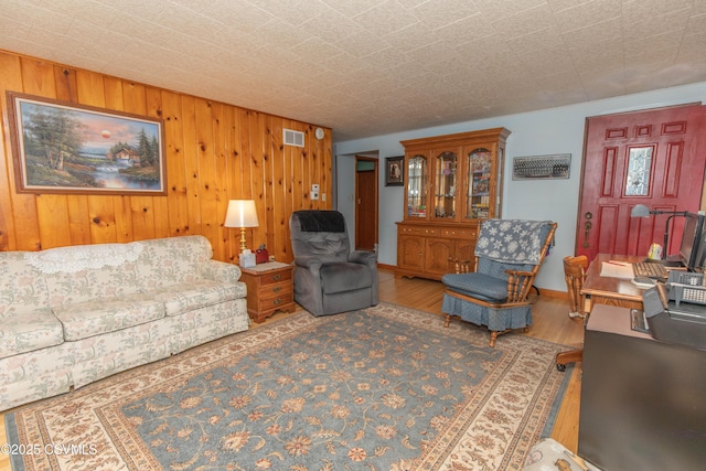 2256 Crossroads Dr, Lewisburg, PA 17837 - living room with wood finished floors, wood walls, and baseboards