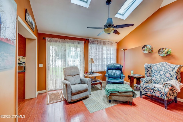 1207 E 5th St, Berwick, PA 18603 - living area with a skylight, wood finished floors, a ceiling fan, high vaulted ceiling, and baseboards