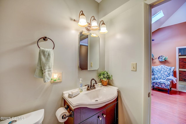 1207 E 5th St, Berwick, PA 18603 - bathroom featuring vanity, toilet, wood finished floors, a skylight, and lofted ceiling