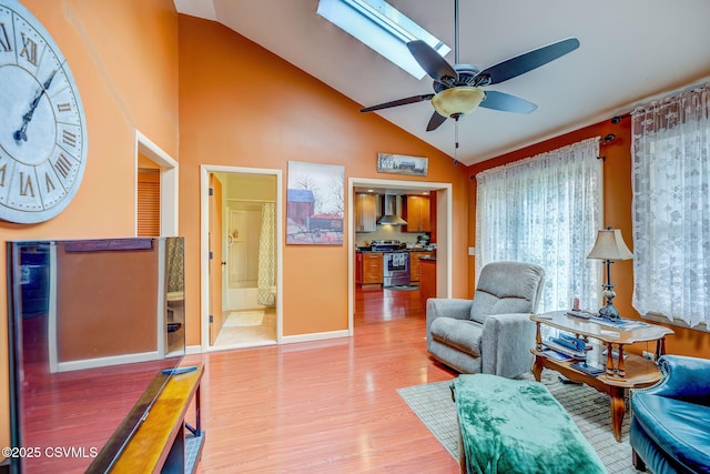 1207 E 5th St, Berwick, PA 18603 - living area featuring ceiling fan, light wood finished floors, baseboards, high vaulted ceiling, and a skylight