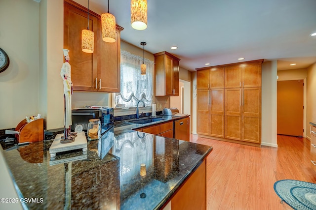 1207 E 5th St, Berwick, PA 18603 - kitchen with a sink, light wood-type flooring, brown cabinets, dark stone counters, and pendant lighting