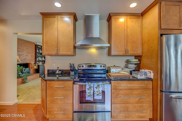 1207 E 5th St, Berwick, PA 18603 - kitchen with appliances with stainless steel finishes, wall chimney range hood, dark stone counters, brown cabinets, and light wood finished floors