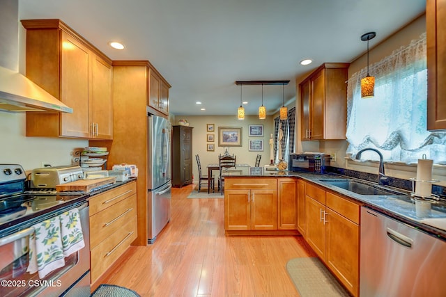 1207 E 5th St, Berwick, PA 18603 - kitchen featuring wall chimney range hood, appliances with stainless steel finishes, a sink, light wood-style flooring, and decorative light fixtures
