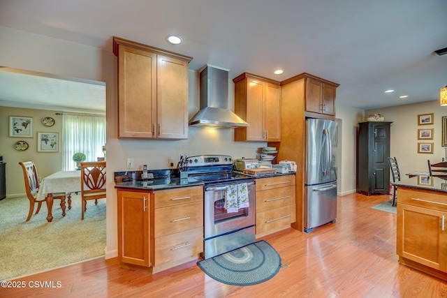 1207 E 5th St, Berwick, PA 18603 - kitchen featuring wall chimney range hood, appliances with stainless steel finishes, brown cabinetry, dark stone counters, and recessed lighting