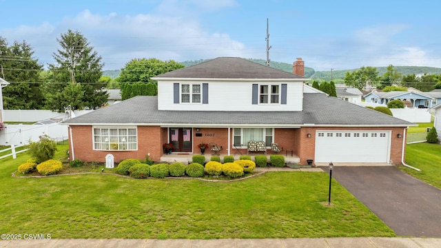 1207 E 5th St, Berwick, PA 18603 - traditional home featuring brick siding, an attached garage, and a porch
