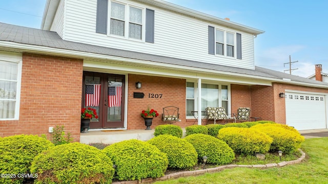 1207 E 5th St, Berwick, PA 18603 - property entrance with brick siding, a garage, and french doors