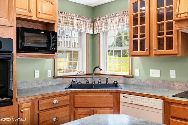 620 Sunset Dr, Bloomsburg, PA 17815 - kitchen with black appliances, a sink, and glass insert cabinets