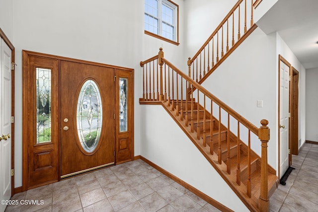 620 Sunset Dr, Bloomsburg, PA 17815 - entryway featuring a towering ceiling, stairs, baseboards, and light tile patterned flooring