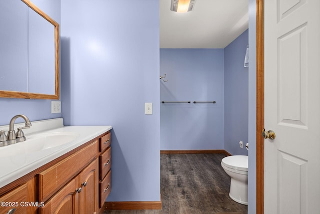 620 Sunset Dr, Bloomsburg, PA 17815 - bathroom with vanity, toilet, wood finished floors, and baseboards