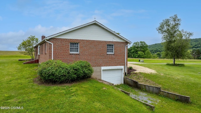 162 Liberty Valley Rd, Danville, PA 17821 - view of side of property featuring an attached garage, brick siding, a chimney, and a lawn
