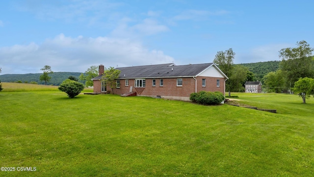 162 Liberty Valley Rd, Danville, PA 17821 - rear view of property with brick siding, a chimney, and a lawn