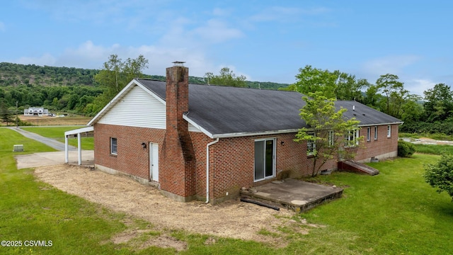 162 Liberty Valley Rd, Danville, PA 17821 - rear view of property with a lawn, brick siding, a chimney, and roof with shingles