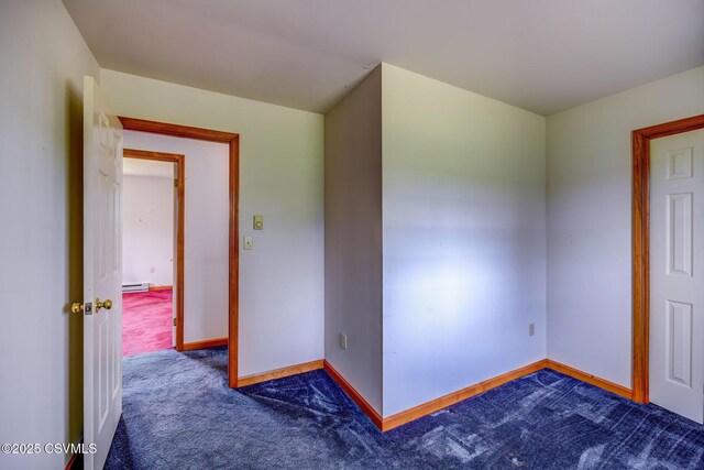 162 Liberty Valley Rd, Danville, PA 17821 - empty room featuring dark carpet, baseboards, and a baseboard radiator