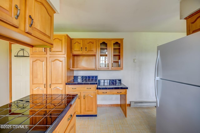 162 Liberty Valley Rd, Danville, PA 17821 - kitchen featuring freestanding refrigerator, tile counters, baseboard heating, glass insert cabinets, and light floors