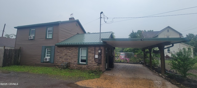 260 Iron St, Berwick, PA 18603 - view of side of home with a chimney, driveway, metal roof, a carport, and cooling unit