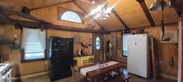 260 Iron St, Berwick, PA 18603 - kitchen with black fridge, freestanding refrigerator, lofted ceiling, wood walls, and wood finished floors