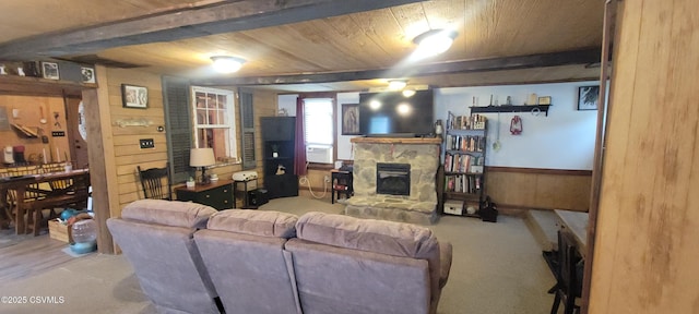 260 Iron St, Berwick, PA 18603 - living room featuring carpet floors, a stone fireplace, wooden walls, and wood ceiling