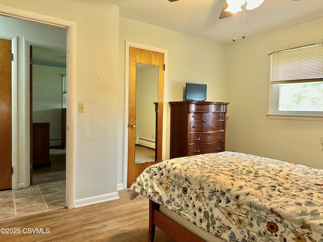 2 E 11th Ave, Shamokin Dam, PA 17876 - bedroom featuring a baseboard radiator, wood finished floors, and baseboards
