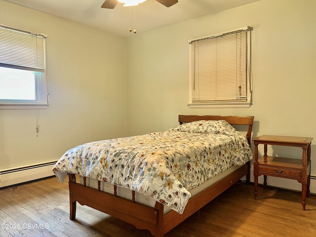 2 E 11th Ave, Shamokin Dam, PA 17876 - bedroom with wood finished floors, ceiling fan, and a baseboard heating unit