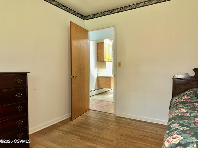 2 E 11th Ave, Shamokin Dam, PA 17876 - bedroom featuring a baseboard heating unit, wood finished floors, and baseboards
