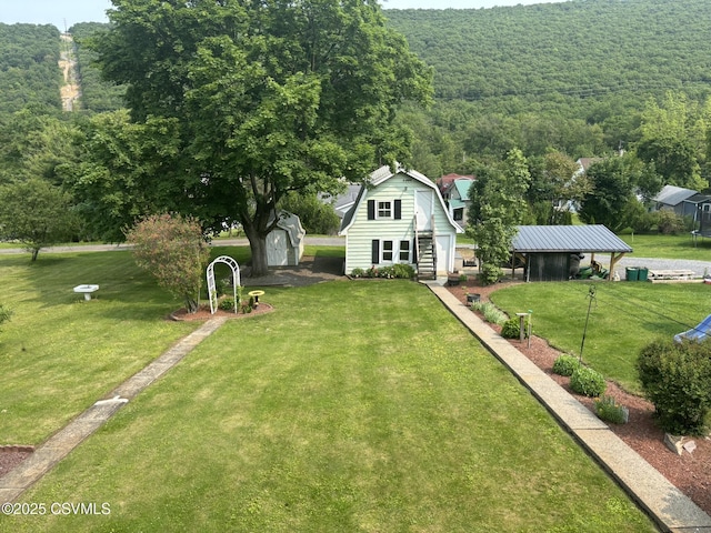 321 E Shamokin St, Trevorton, PA 17881 - view of front facade featuring a view of trees, a front yard, and a gambrel roof