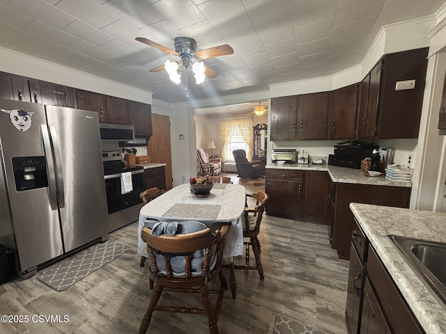 321 E Shamokin St, Trevorton, PA 17881 - kitchen featuring appliances with stainless steel finishes, ceiling fan, dark brown cabinetry, wood finished floors, and ornamental molding