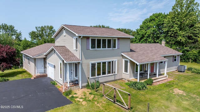 67 Center School Rd, Elysburg, PA 17824 - traditional-style house featuring roof with shingles, a garage, central air condition unit, and a front yard
