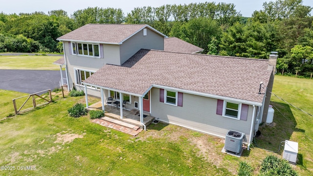 67 Center School Rd, Elysburg, PA 17824 - view of front of home featuring central AC, roof with shingles, and a chimney