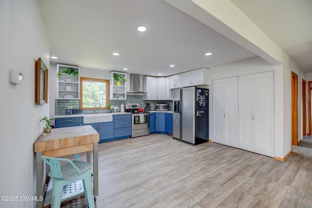 67 Center School Rd, Elysburg, PA 17824 - kitchen featuring stainless steel appliances, wall chimney range hood, blue cabinets, open shelves, and light countertops