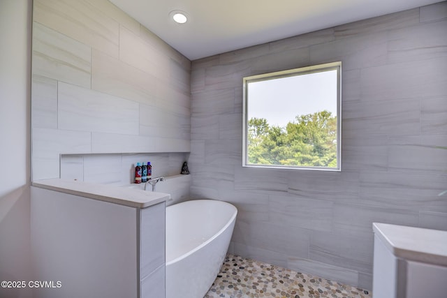 67 Center School Rd, Elysburg, PA 17824 - bathroom featuring a soaking tub, tile walls, and tile patterned floors