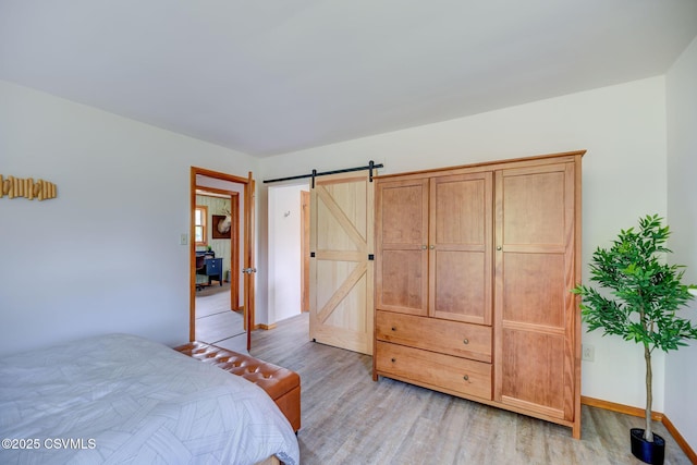 67 Center School Rd, Elysburg, PA 17824 - bedroom with light wood finished floors, a barn door, and baseboards