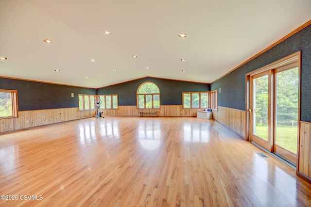 67 Center School Rd, Elysburg, PA 17824 - unfurnished living room with wainscoting, light wood-style floors, vaulted ceiling, recessed lighting, and wood walls