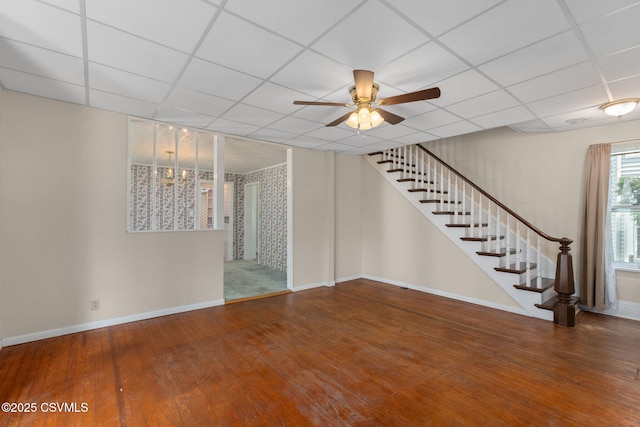651 E Market St, Danville, PA 17821 - unfurnished living room with a drop ceiling, wood finished floors, ceiling fan, stairway, and baseboards