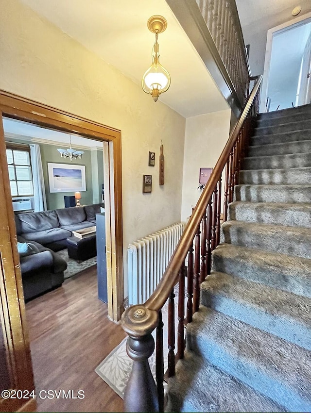 406 W Spruce St, Shamokin, PA 17872 - stairs with radiator, wood finished floors, and a chandelier