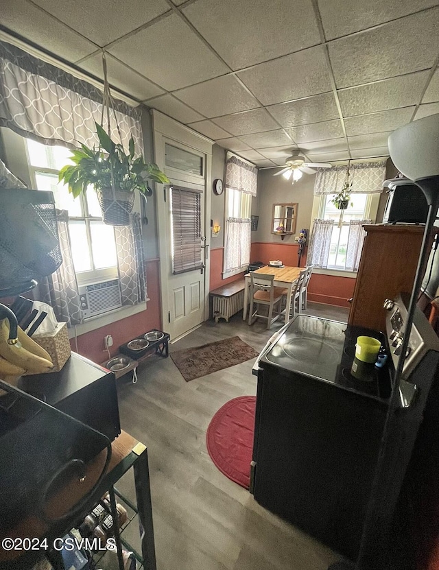 406 W Spruce St, Shamokin, PA 17872 - living room with healthy amount of natural light, radiator heating unit, wood finished floors, a drop ceiling, and cooling unit