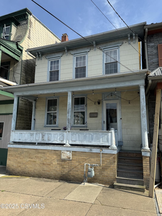 406 W Spruce St, Shamokin, PA 17872 - view of front facade with covered porch and a chimney