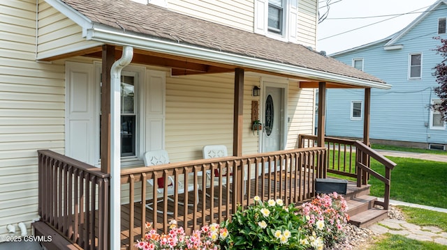 221 Charles St, Berwick, PA 18603 - view of exterior entry featuring a porch, roof with shingles, and a lawn