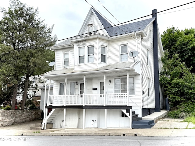 423 E Dewart St, Shamokin, PA 17872 - view of front of home with a porch, stairway, roof with shingles, and a chimney