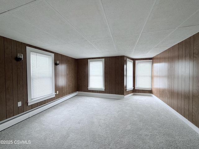 423 E Dewart St, Shamokin, PA 17872 - carpeted spare room with a baseboard radiator, wood walls, and baseboards