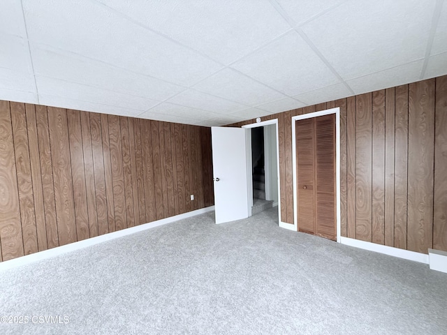 423 E Dewart St, Shamokin, PA 17872 - unfurnished bedroom featuring a drop ceiling, wooden walls, and carpet floors