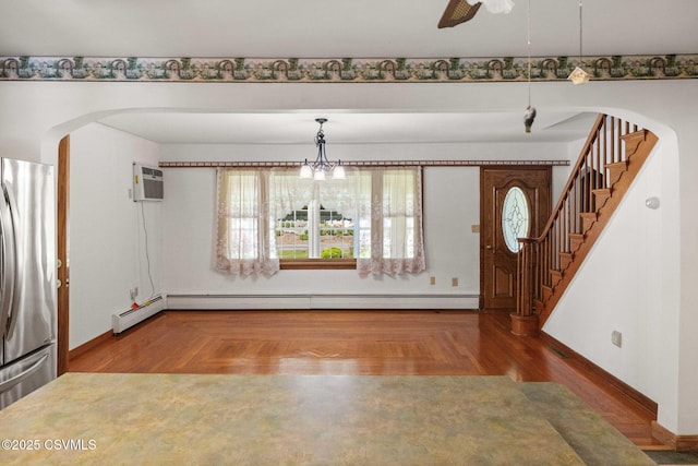 776 Continental Blvd, Danville, PA 17821 - foyer entrance featuring arched walkways, stairs, baseboards, a baseboard heating unit, and parquet flooring