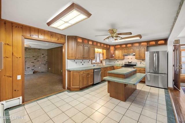 776 Continental Blvd, Danville, PA 17821 - kitchen with appliances with stainless steel finishes, under cabinet range hood, a ceiling fan, a sink, and wooden walls