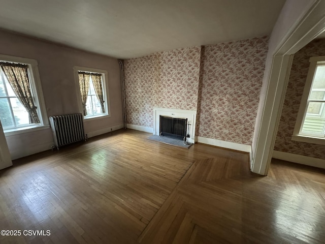 127 N 3rd St, Lewisburg, PA 17837 - unfurnished living room with radiator, wallpapered walls, a fireplace, baseboards, and parquet flooring
