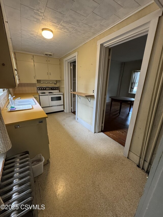 127 N 3rd St, Lewisburg, PA 17837 - kitchen featuring white range with electric stovetop, a sink, light countertops, and cream cabinets