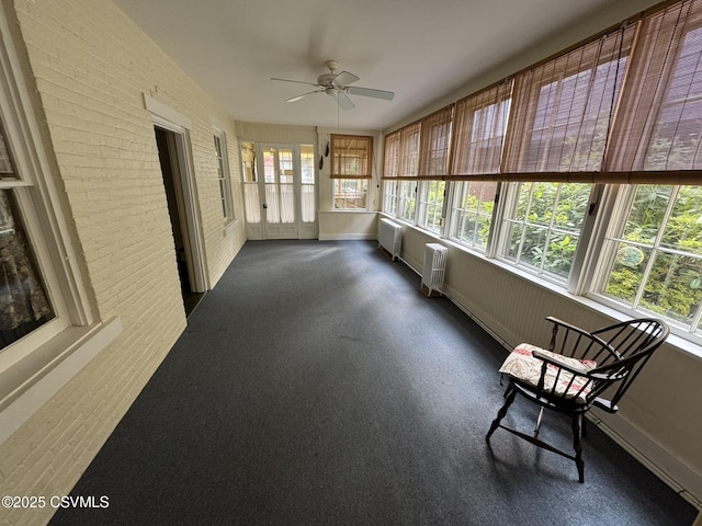 127 N 3rd St, Lewisburg, PA 17837 - unfurnished sunroom featuring radiator, brick wall, and baseboards