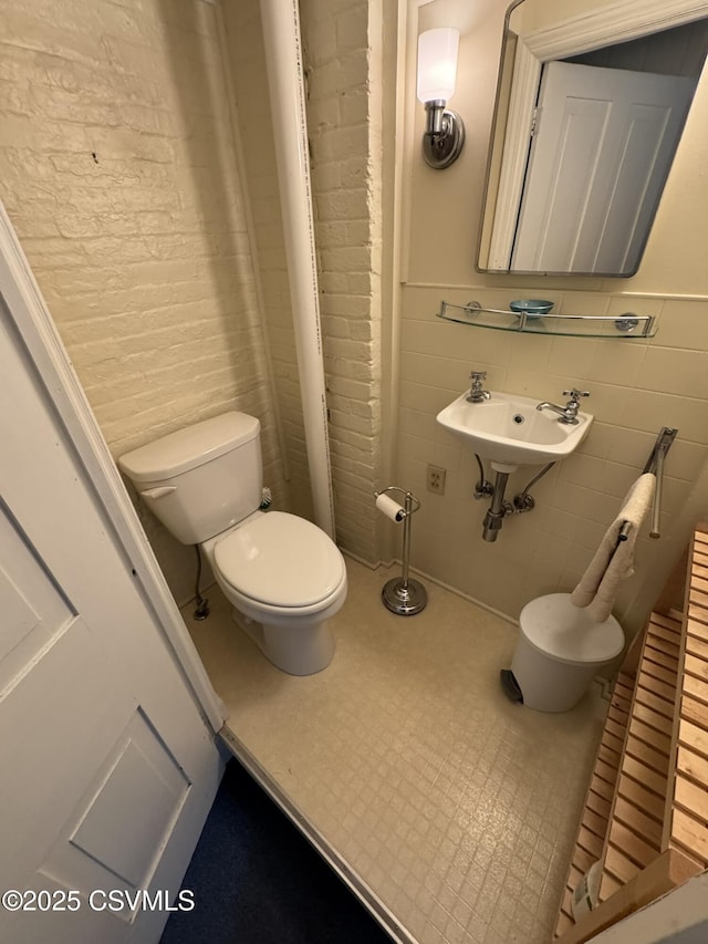 127 N 3rd St, Lewisburg, PA 17837 - bathroom featuring toilet, tile walls, and a sink