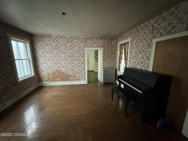 127 N 3rd St, Lewisburg, PA 17837 - sitting room with radiator heating unit, wallpapered walls, and baseboards