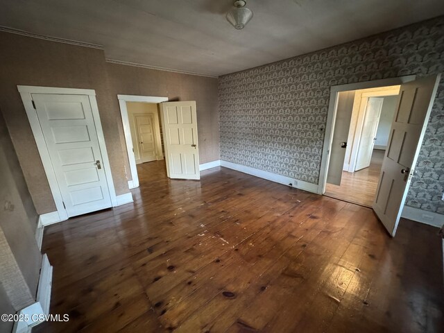 127 N 3rd St, Lewisburg, PA 17837 - unfurnished bedroom featuring dark wood-style floors, baseboards, and wallpapered walls